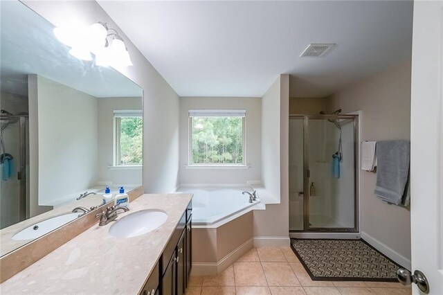 full bath featuring a stall shower, vanity, visible vents, and tile patterned floors