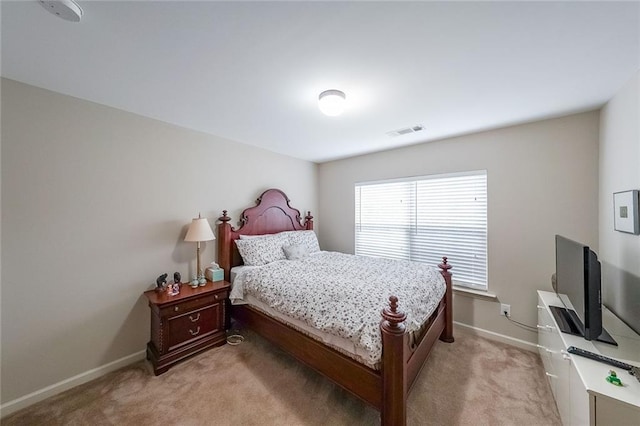 bedroom featuring visible vents, light carpet, and baseboards
