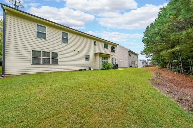 back of property featuring a lawn