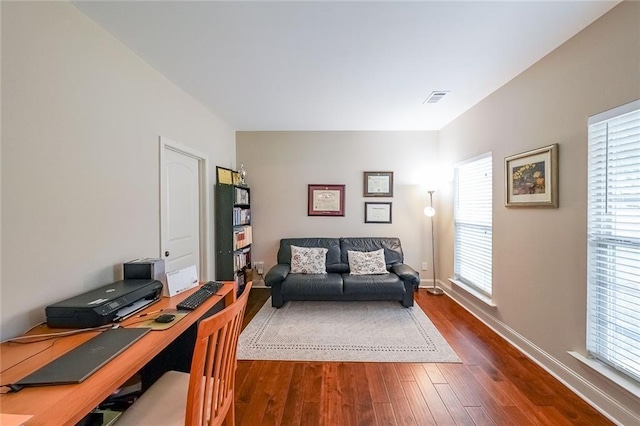 home office featuring dark wood-type flooring, visible vents, and baseboards