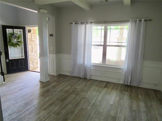 58 Torero Trl, Newnan, GA 30263 - spare room with beam ceiling, a decorative wall, wood finished floors, a wainscoted wall, and ornate columns