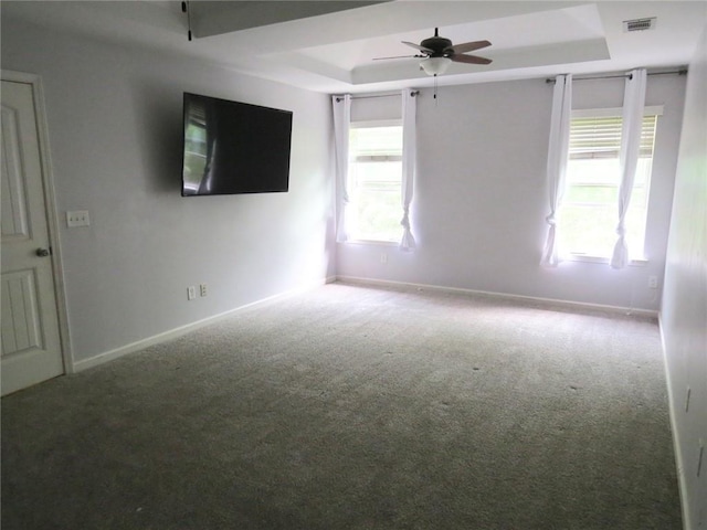58 Torero Trl, Newnan, GA 30263 - carpeted spare room with a tray ceiling, ceiling fan, and baseboards