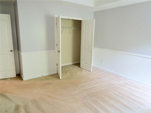 58 Torero Trl, Newnan, GA 30263 - unfurnished bedroom featuring carpet floors, a closet, and baseboards