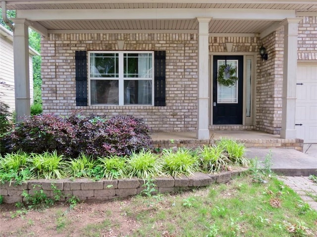 58 Torero Trl, Newnan, GA 30263 - property entrance featuring brick siding, a porch, and a garage