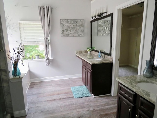 58 Torero Trl, Newnan, GA 30263 - bathroom with two vanities, wood finished floors, and baseboards