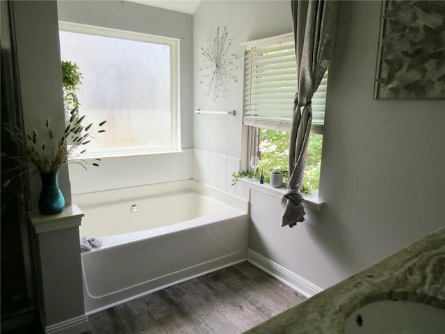 58 Torero Trl, Newnan, GA 30263 - full bathroom featuring a garden tub, wood finished floors, and baseboards