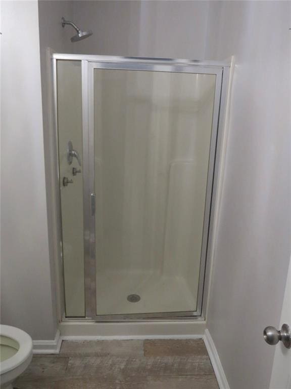 58 Torero Trl, Newnan, GA 30263 - bathroom with a shower stall, baseboards, and toilet