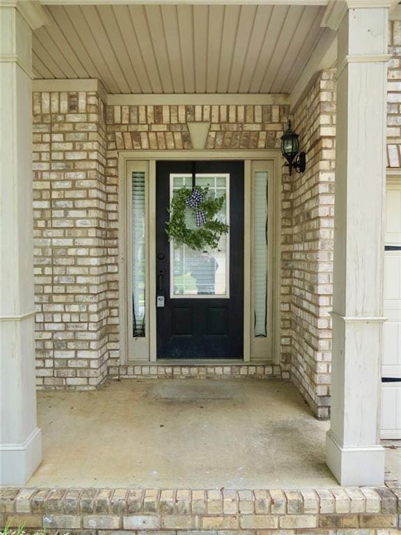 58 Torero Trl, Newnan, GA 30263 - doorway to property with brick siding and a porch