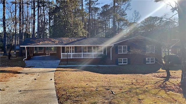 ranch-style home with a porch and a carport