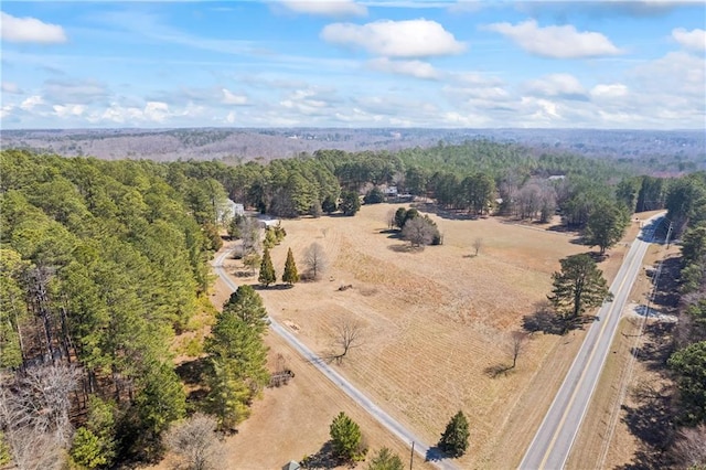 birds eye view of property featuring a forest view and a rural view