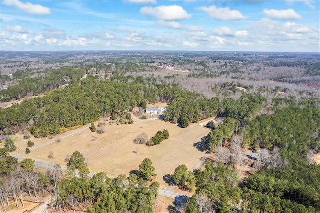 drone / aerial view featuring a wooded view