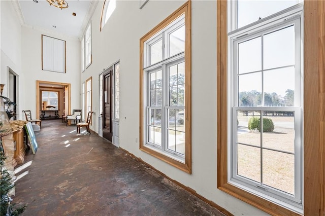 corridor with a towering ceiling and concrete floors