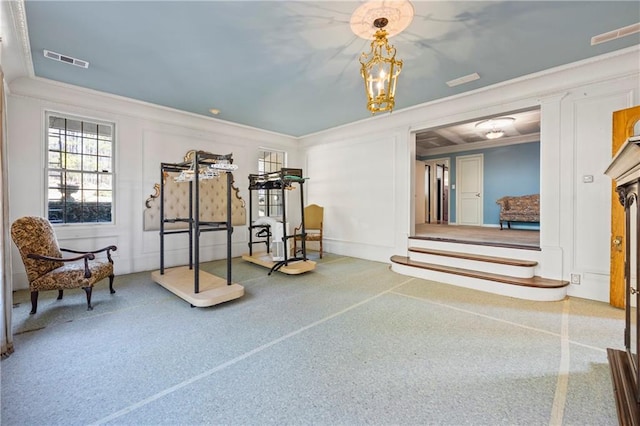 workout room with visible vents and ornamental molding