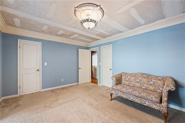 sitting room featuring carpet, ornamental molding, and baseboards