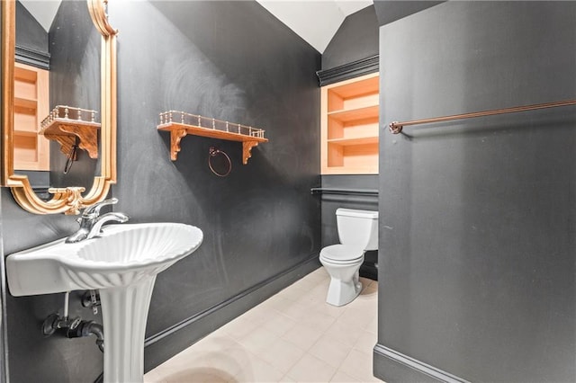 bathroom featuring toilet and lofted ceiling