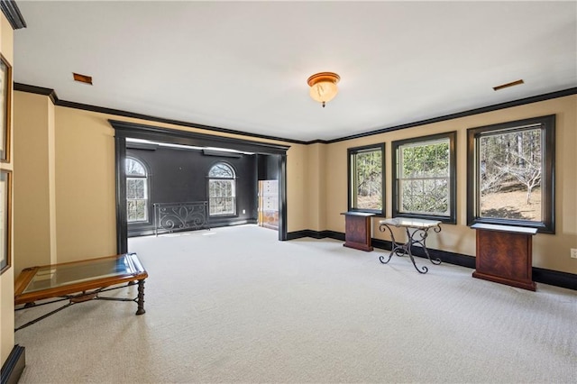 sitting room featuring carpet floors, ornamental molding, and baseboards