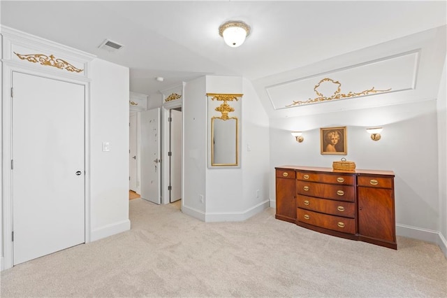 bedroom with light colored carpet, vaulted ceiling, visible vents, and baseboards