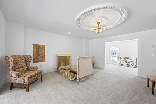 bedroom featuring baseboards, a raised ceiling, and light colored carpet