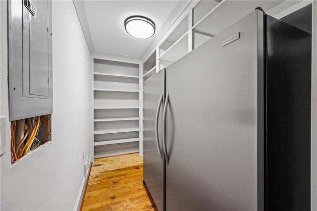 interior space with light wood-style floors and freestanding refrigerator