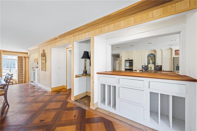 kitchen with wooden counters and baseboards