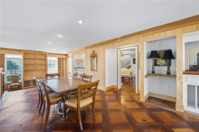 dining area featuring recessed lighting, wood walls, and baseboards