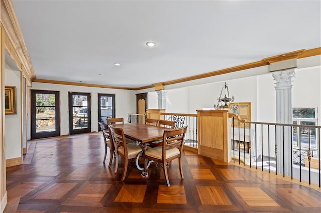 dining area with ornate columns, a notable chandelier, crown molding, and recessed lighting