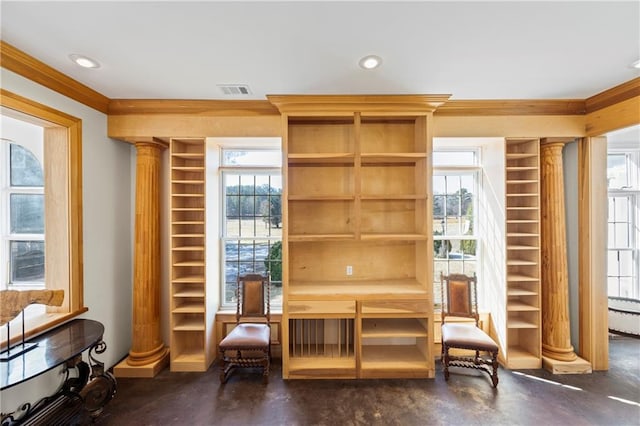 living area featuring finished concrete flooring, ornamental molding, recessed lighting, and ornate columns