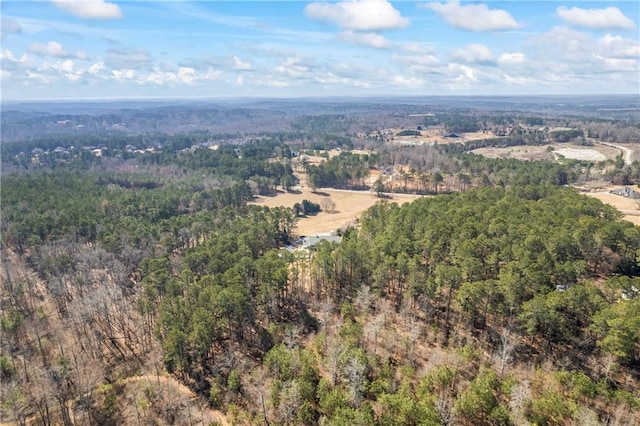 drone / aerial view featuring a wooded view