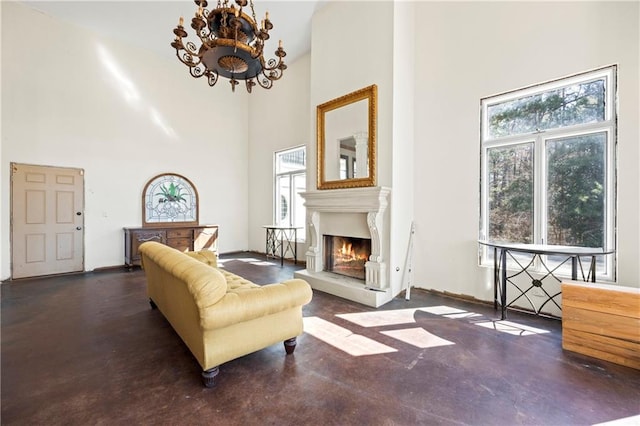 living area with concrete flooring and a towering ceiling