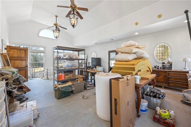 miscellaneous room featuring concrete flooring, ceiling fan, and high vaulted ceiling