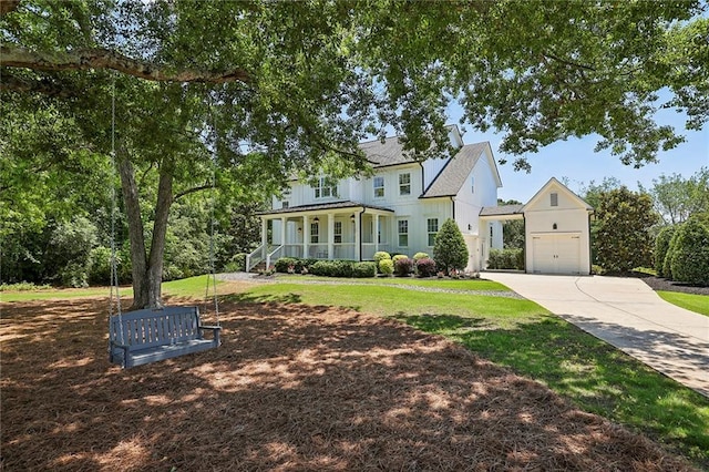 view of front of home with a garage, a porch, and a front lawn