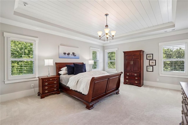 bedroom featuring a raised ceiling and multiple windows