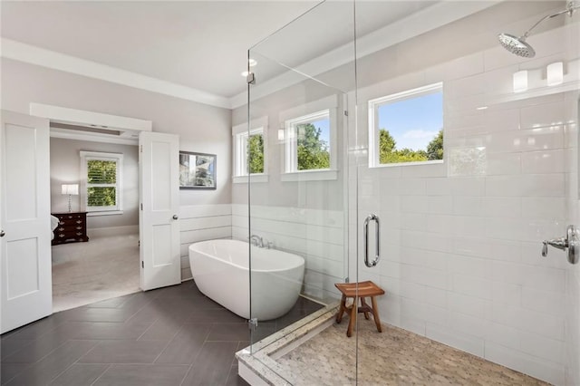 full bath featuring a shower stall, crown molding, and a freestanding bath