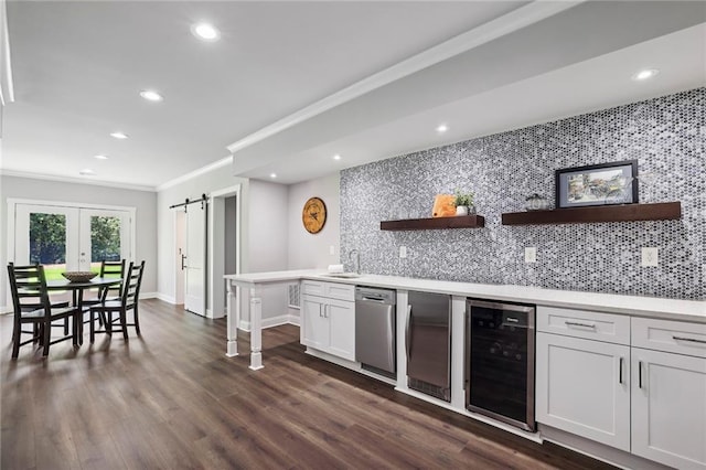 kitchen featuring tasteful backsplash, a barn door, wine cooler, and open shelves