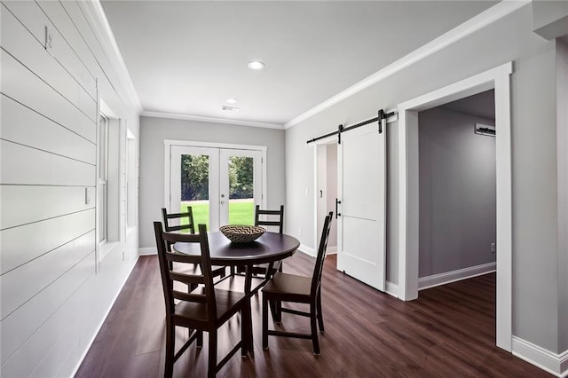 dining room featuring dark wood-style flooring, french doors, crown molding, a barn door, and baseboards