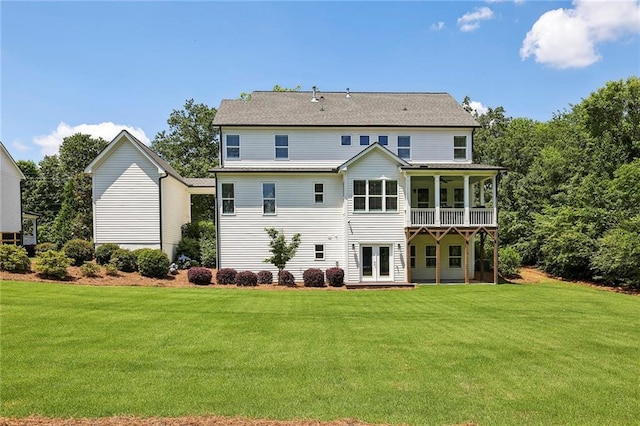 back of property featuring french doors, a ceiling fan, and a yard