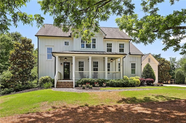 modern farmhouse style home with metal roof, covered porch, a standing seam roof, board and batten siding, and a front yard