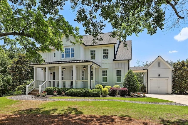 modern farmhouse style home with roof with shingles, a porch, board and batten siding, and a front yard