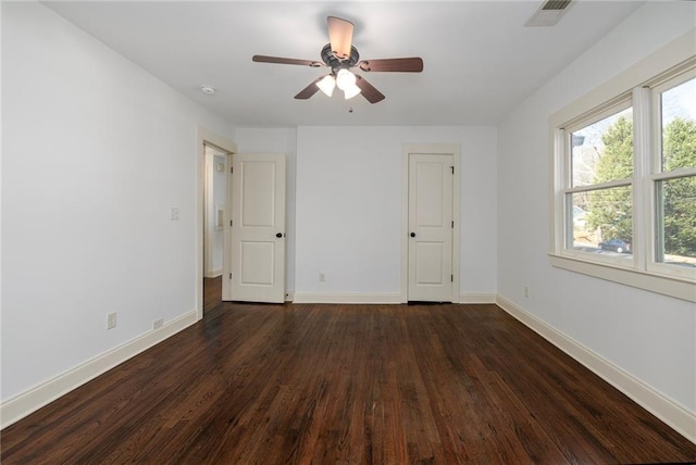 unfurnished bedroom featuring ceiling fan and dark hardwood / wood-style flooring