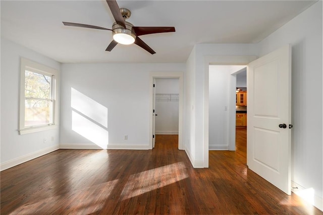 spare room featuring ceiling fan and dark wood-type flooring