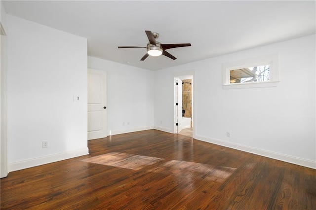 empty room with dark hardwood / wood-style floors and ceiling fan