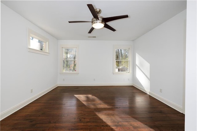 unfurnished room featuring dark hardwood / wood-style floors, ceiling fan, and a healthy amount of sunlight