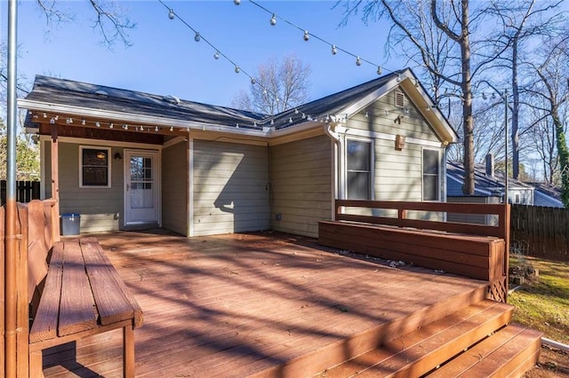 rear view of house featuring a wooden deck