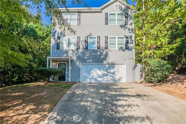 view of front of property featuring driveway and an attached garage