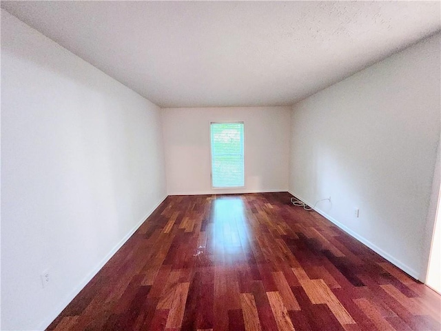 unfurnished room featuring hardwood / wood-style flooring