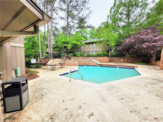 view of swimming pool with a patio area