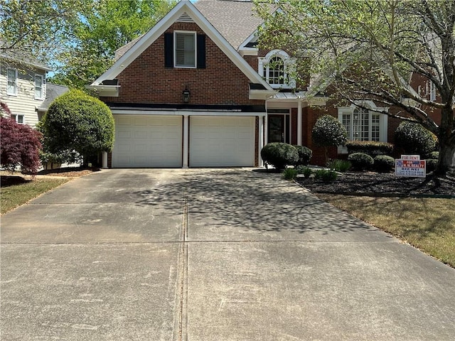 2612 Peterboro Row, Marietta, GA 30062 - traditional-style house featuring brick siding, driveway, and a garage