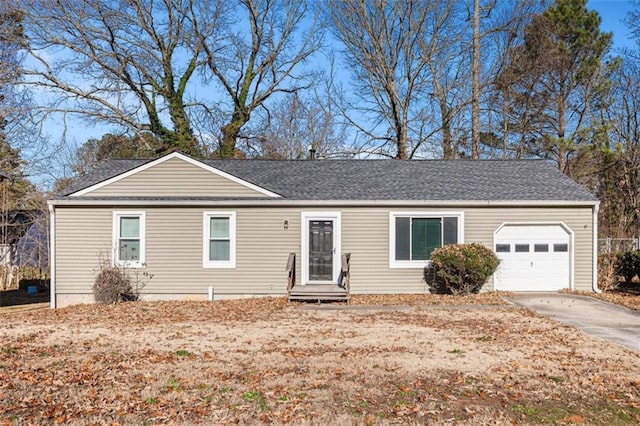 ranch-style house featuring entry steps, driveway, a garage, and roof with shingles