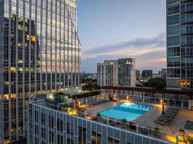 pool at dusk with a view of city