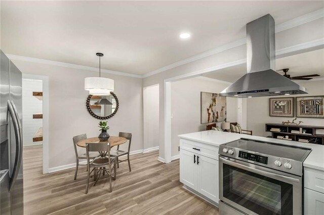 1282 Westridge Rd SW, Atlanta, GA 30311 - kitchen featuring light countertops, ornamental molding, light wood-style floors, island range hood, and stainless steel appliances